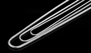 Close-up of three different thicknesses of polished silver snake chains in stainless steel