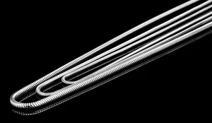 Macro shot of silver round snake chain necklace with high-gloss polished metallic texture