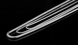 Macro detail of polished silver round snake bone chains with metallic texture and flexibility