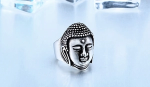 Detailed close-up of a vintage stainless steel Buddha head ring with oxidized silver finish