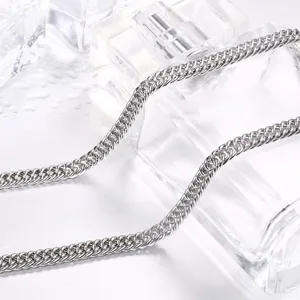 Polished silver men's titanium steel flat Cuban link chain necklace on watery background