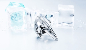Macro shot of Viking raven skull ring in stainless steel with a vintage finish on ice cubes