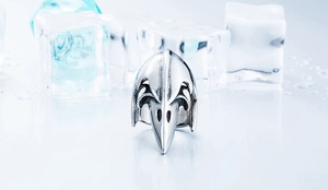 Detailed view of Viking raven skull ring on ice background with vintage silver finish