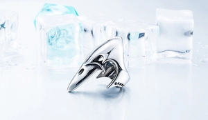 Detailed view of Viking raven skull ring with vintage finish on cold ice background