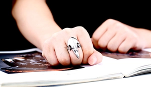 Detailed close-up of a silver Viking crow skull ring with vintage punk aesthetic style