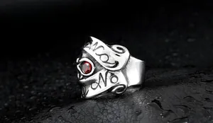Detail of punk skull ring in silver steel with red gem eye and intricate engravings