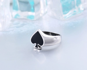 Polished stainless steel spade ring featuring black enamel inlay on a mirrored surface