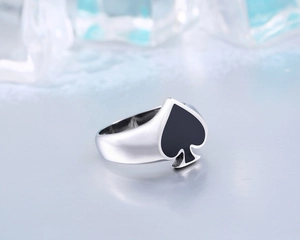 Close-up of heart spade ring in polished stainless steel with black enamel detail