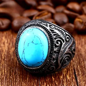 Macro shot of vintage titanium ring with blue turquoise stone and engraved patterns