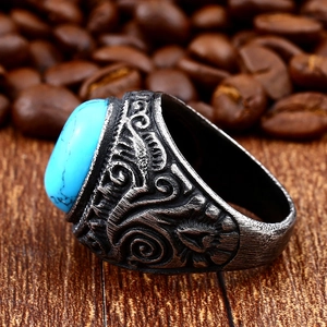 Macro detail of men vintage steel ring with blue turquoise stone and floral carvings