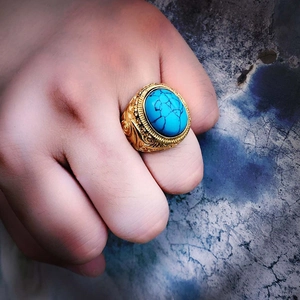 Detailed view of a vintage titanium steel ring featuring an oval turquoise gemstone inlay