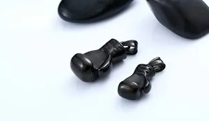 Detail of black boxing glove pendants in two sizes with realistic stitching texture
