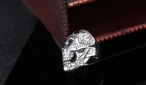 Macro detail of gothic stainless steel sugar skull ring with ornate floral engraving