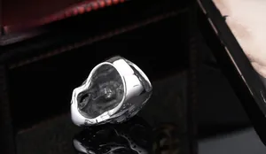 Macro shot of detailed skull embossing on inner band of polished stainless steel ring