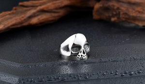 Makroaufnahme eines Gothic Totenkopfrings mit Vintage-Finish auf dunklem Stein