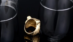 Detailed view of the golden tiger head ring band featuring fine hair-like engraved texture