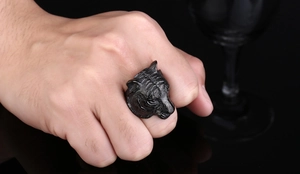 Detailed close-up of a matte black tiger head ring in embossed stainless steel for men