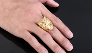 Close-up of golden tiger head ring for men featuring detailed 3D relief on a hand