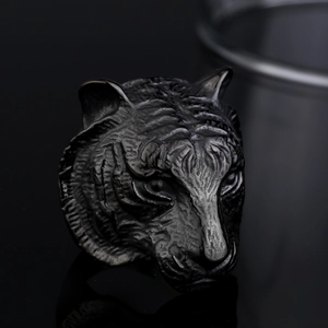 Men's matte black tiger head ring in stainless steel with detailed animal relief carving
