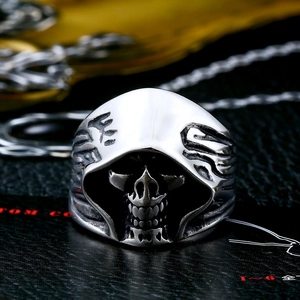 Macro view of vintage stainless steel reaper skull ring with gothic hood details