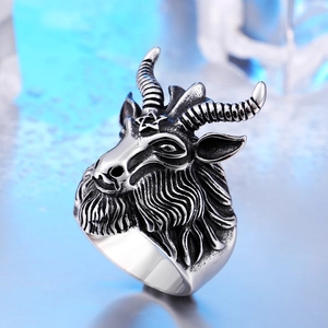 Macro shot of punk style stainless steel Baphomet ram head ring with pentagram detail
