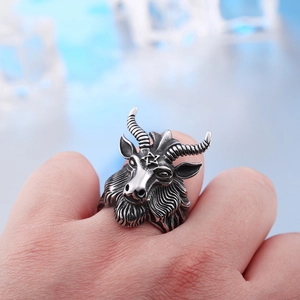 Detail showing vintage stainless steel ram head ring with pentagram on man hand