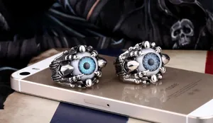 Close-up of retro punk claw rings featuring blue and grey realistic eyeball designs