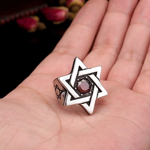 Macro shot of vintage titanium steel ring with hexagram star and red zircon stone
