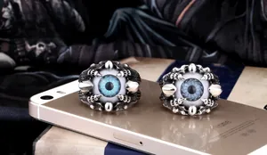 Macro shot of punk style evil eye rings with blue eyeball and metallic eagle claws