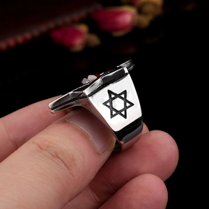 Vintage stainless steel men's ring featuring a red zircon stone and star of David side carvings