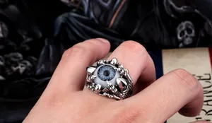 Macro view of gothic male ring featuring a blue eyeball held by detailed metal dragon claws