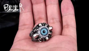 Detailed view of punk style silver claw ring holding a realistic blue eyeball ornament
