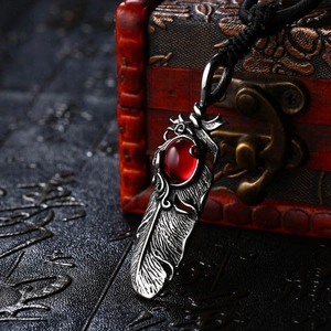 Vintage silver feather pendant with oval red gemstone and black cord necklace
