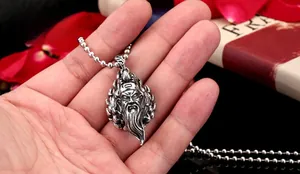 Detailed view of Guan Yu pendant in vintage stainless steel finish with bead chain