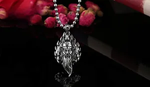 Macro shot of vintage silver Guan Yu warrior pendant with flame relief detail