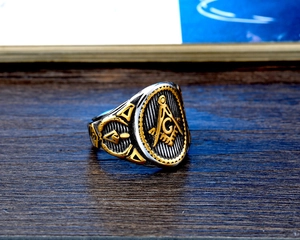 Close-up of vintage stainless steel Masonic signet ring with gold and silver details