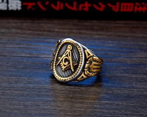 Detailed close-up of two-tone Masonic stainless steel signet ring with engraved emblems