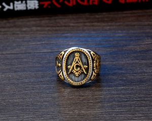 Detailed top view of a men's vintage Freemasonry ring with gold and silver tone finish