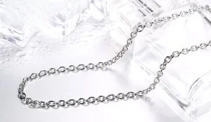 Macro shot of polished silver stainless steel O-chain link necklace with water droplets