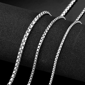 Close-up of polished silver titanium steel box chain showing detailed square welding