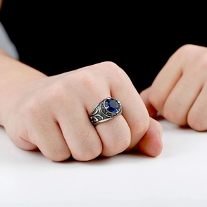 Detail eines Vintage Edelstahlrings für Herren mit blauem Saphir und gravierten Mustern