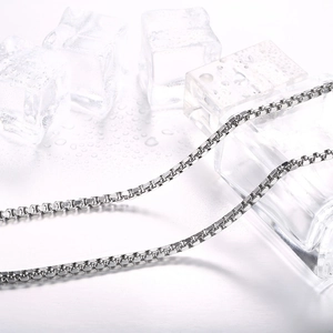 Polished titanium steel box chain necklace for men on crystal clear ice blocks