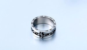 Macro detail of gothic style stainless steel ring with black enamel cross patterns
