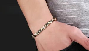 Macro view of gold and silver Byzantine chain bracelet made of polished stainless steel