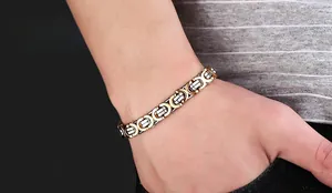 Detail of men's two-tone gold and silver industrial chain bracelet on wrist