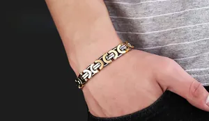 Close-up of men's two-tone gold and silver titanium steel flat Byzantine link bracelet