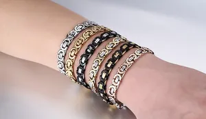 Detailed view of Byzantine style chains in mixed metallic colors on a male wrist