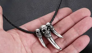 Macro shot of punk style titanium steel triple skull pendant with gothic animal horn design