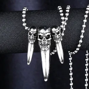 Punk style stainless steel triple skull pendant with long tusks on a bead chain