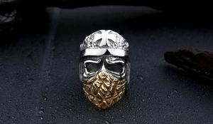 Detailed macro view of punk skull ring with golden mesh mask and cross helmet motif